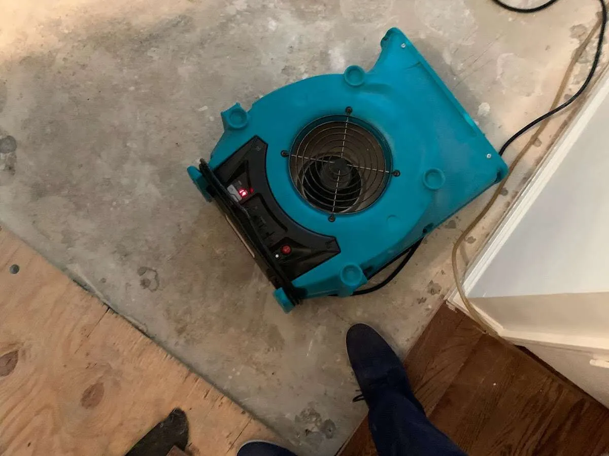 Air mover drying subfloor during Commercial Water Damage Restoration in Mayo